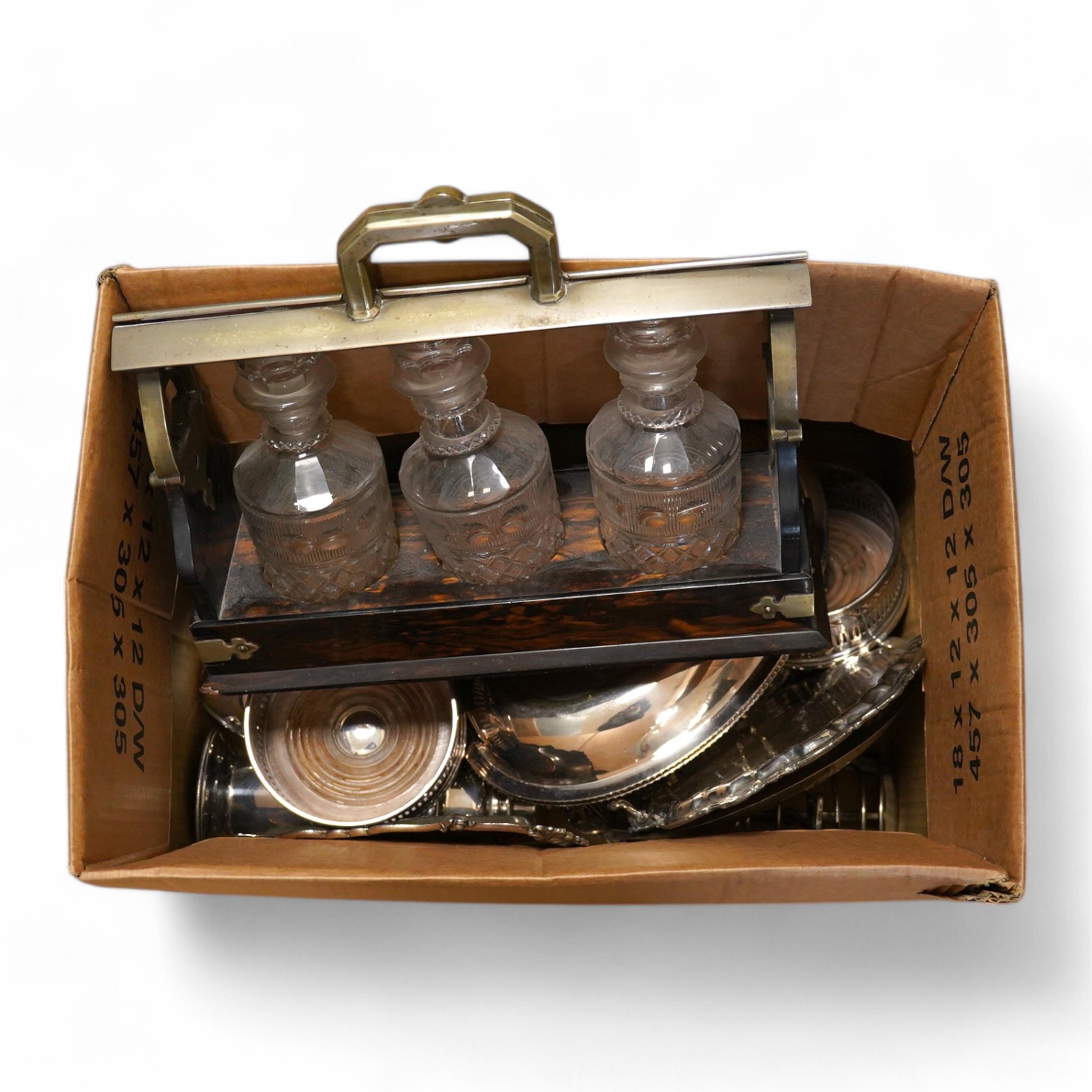 A quantity of assorted plated ware including entrée dishes, toast racks, salvers, pair of coasters and a coromandel wood tantalus (no key) etc.